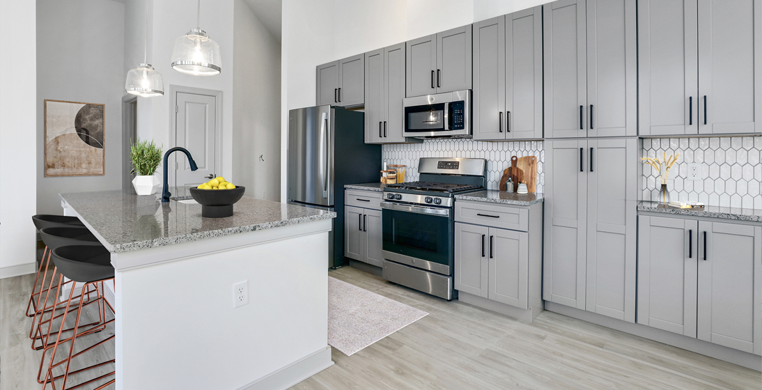 Kitchen with grey cabinets and black finishes