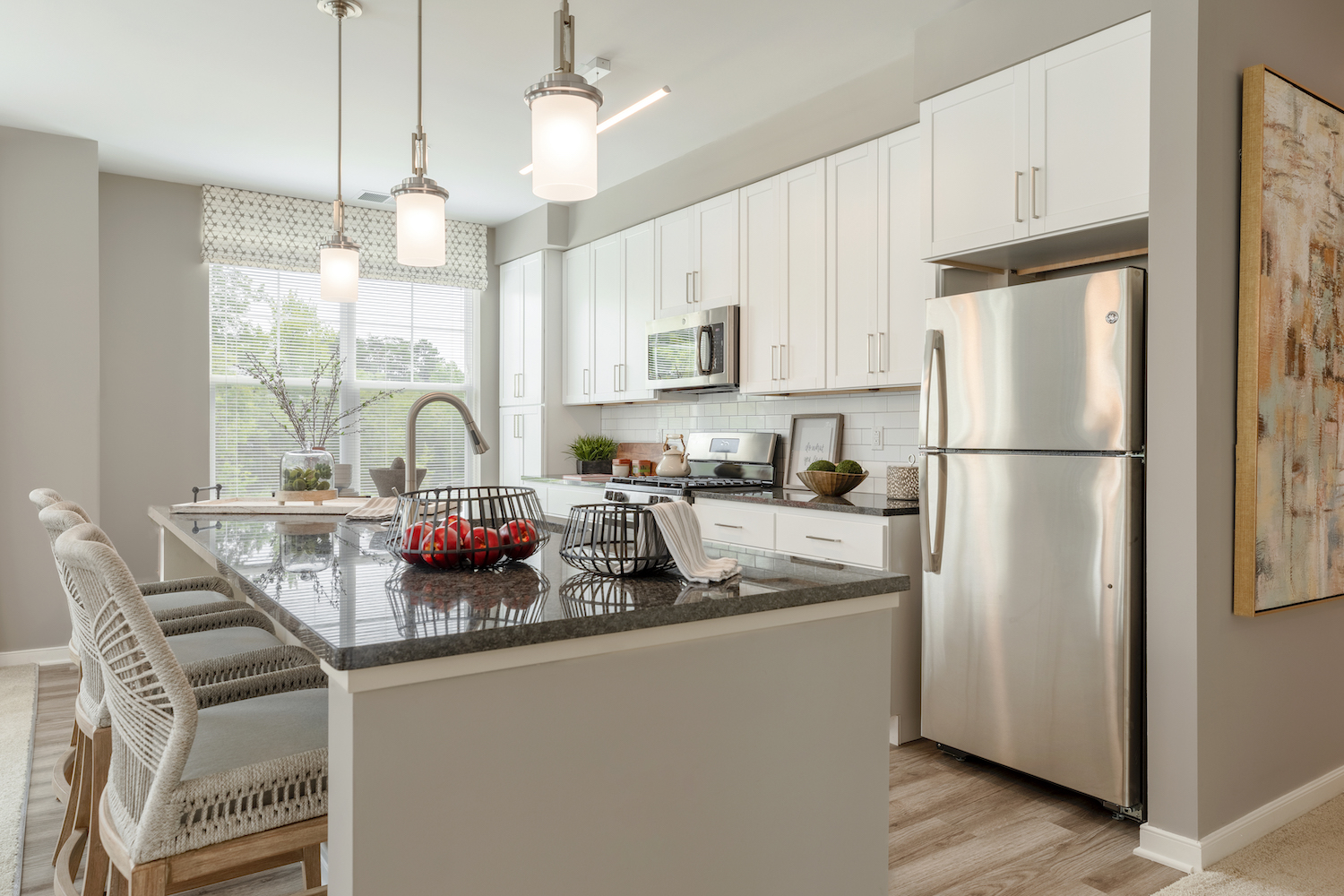 Refinery kitchen with white cabinets and stainless appliances.