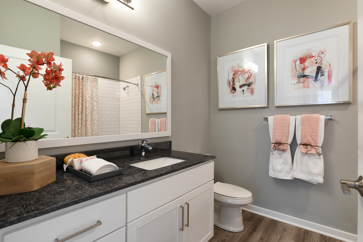 Refinery bathroom with white cabinets and large sink counter area