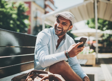 Man laughing while talking on phone